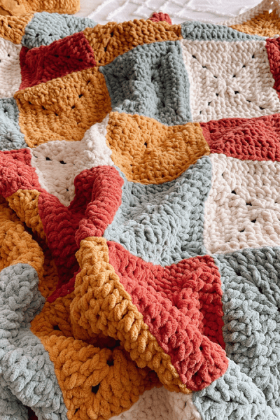 A colorful blanket made out of granny squares